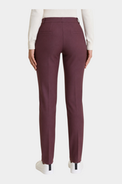 Follower SRL bordeaux cigarette trousers with belt loops and back pockets, worn with a white top and sneakers.