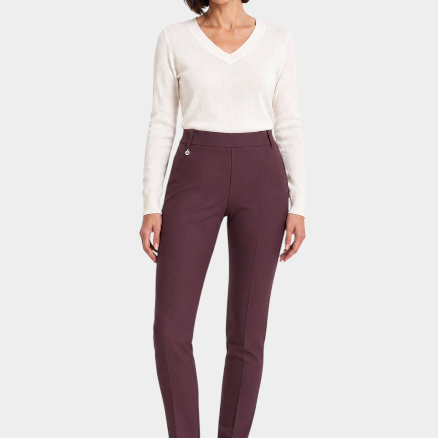Follower SRL bordeaux cigarette trousers with belt loops worn by a woman with a white v-neck sweater and sneakers