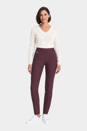 Follower SRL bordeaux cigarette trousers with belt loops worn by a woman with a white v-neck sweater and sneakers