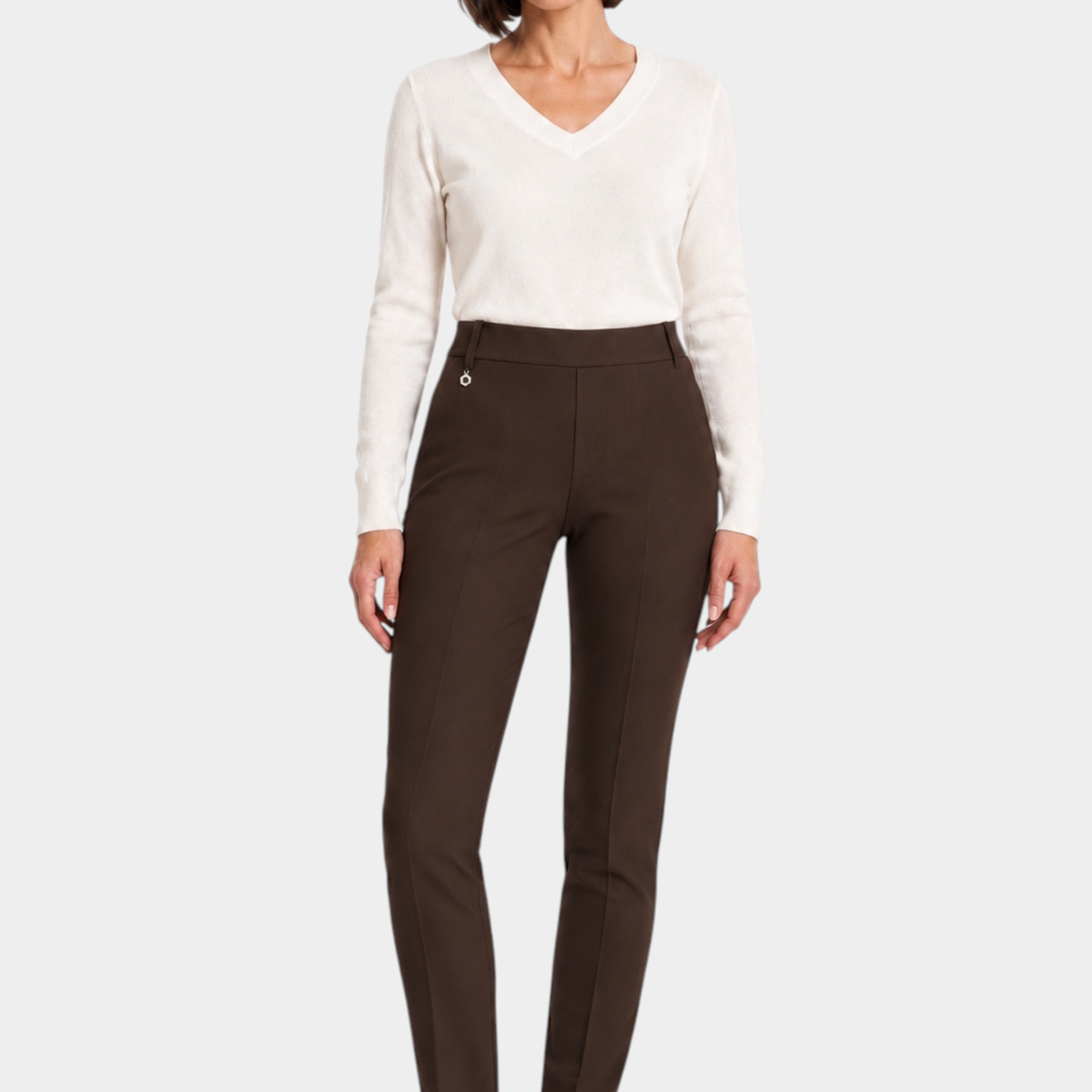 Follower SRL brown cigarette trousers with belt loops worn by a woman with a white v-neck sweater and sneakers