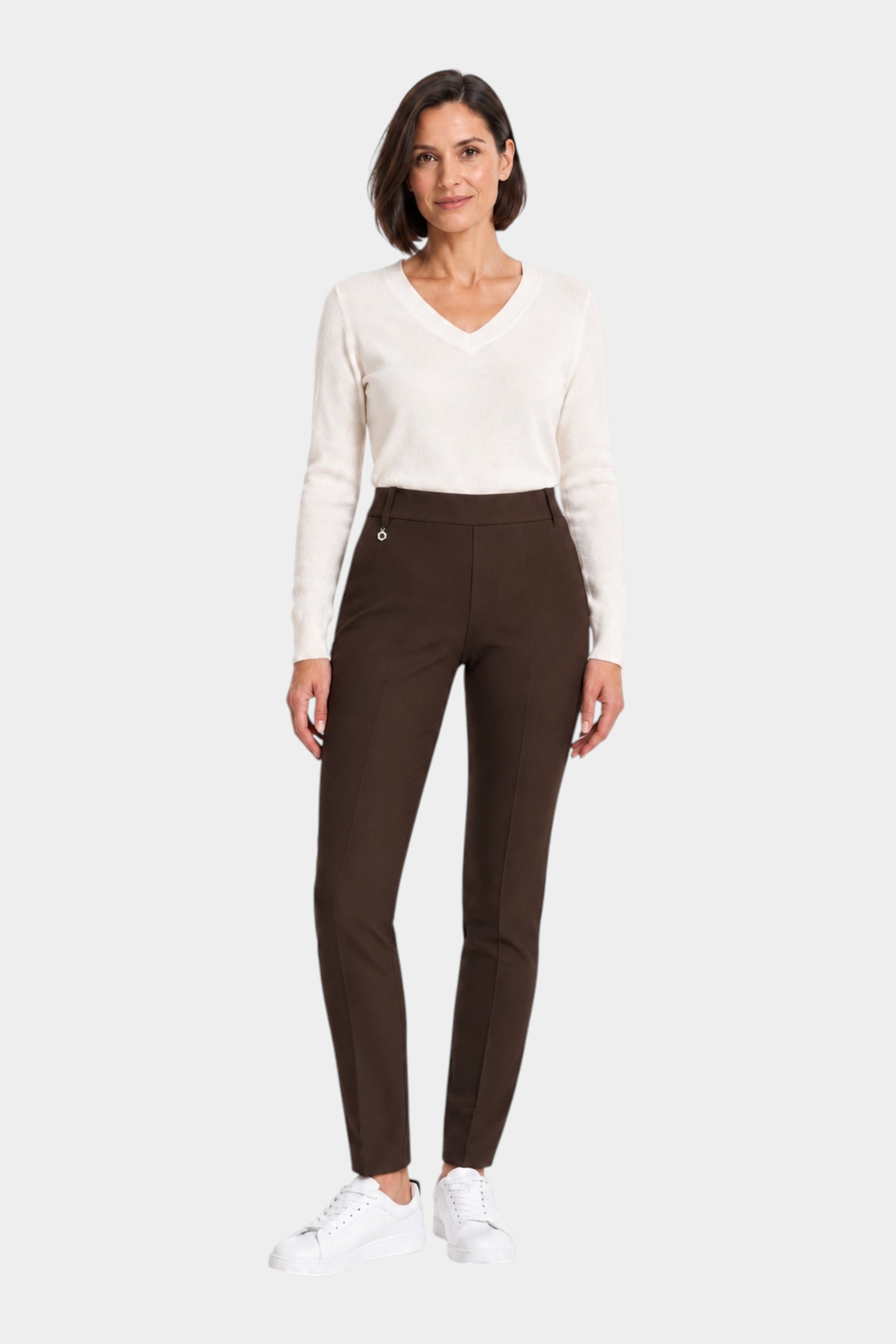 Follower SRL brown cigarette trousers with belt loops worn by a woman with a white v-neck sweater and sneakers