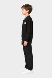 Ragazzo indossa cardigan nero Follower SRL con logo iconico JR dorato sul petto, vista laterale