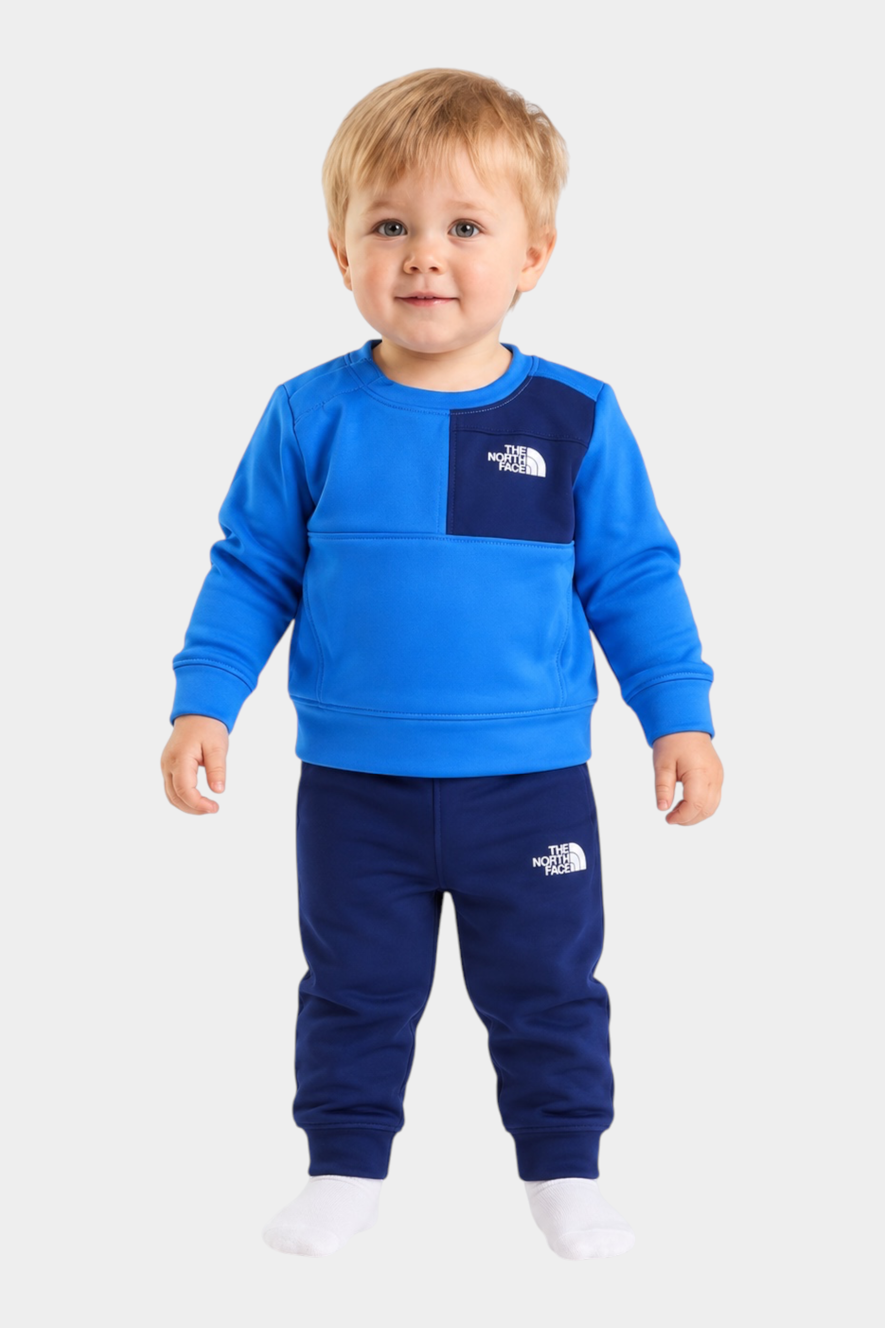 Bambino indossa completo due pezzi Follower SRL THE NORTH FACE blu con felpa e pantaloni sportivi
