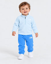 Bambino che indossa un completo due pezzi in pile azzurro Follower SRL con logo The North Face e zip frontale