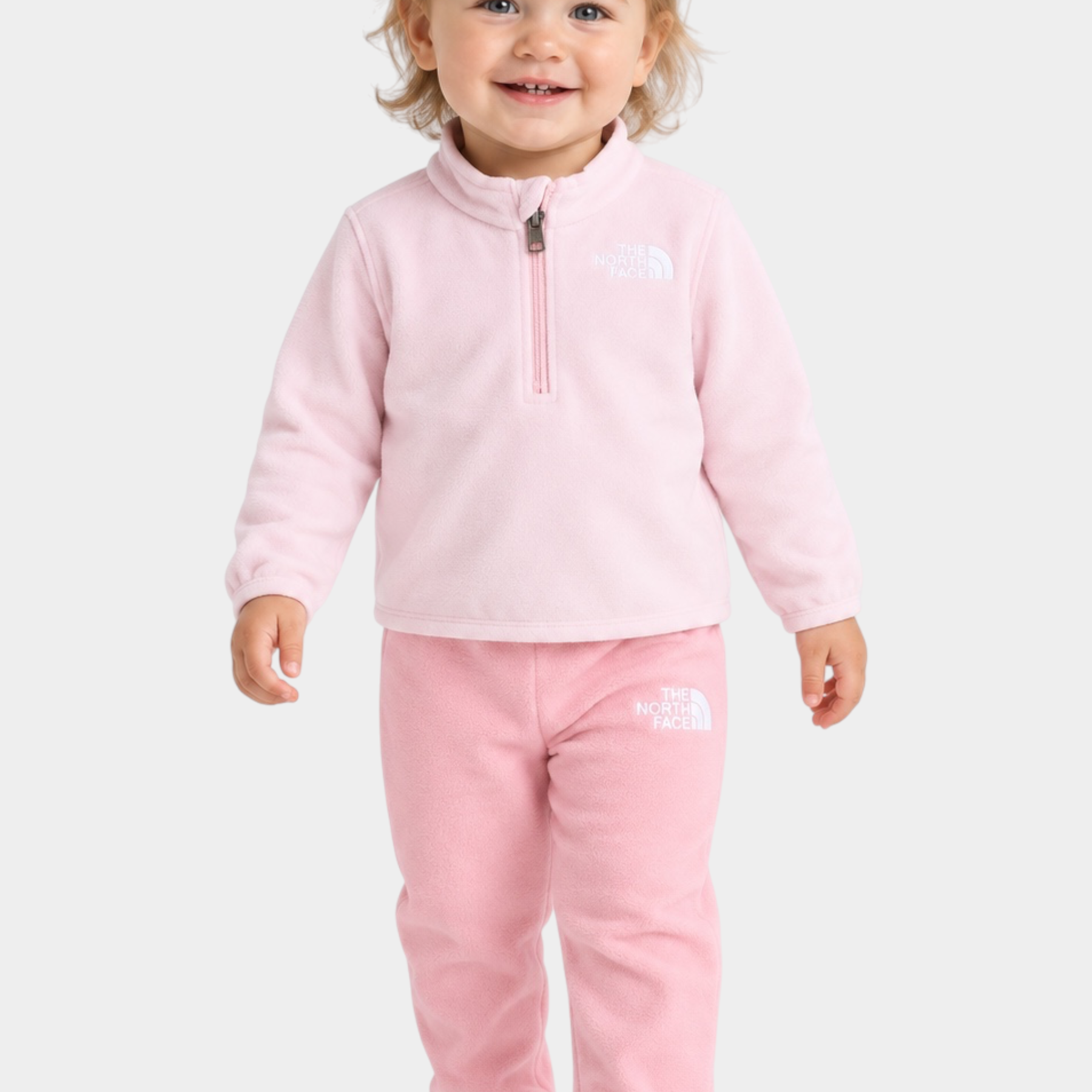 Bambina che indossa il completo due pezzi in pile rosa Glacier di Follower SRL con logo The North Face ricamato