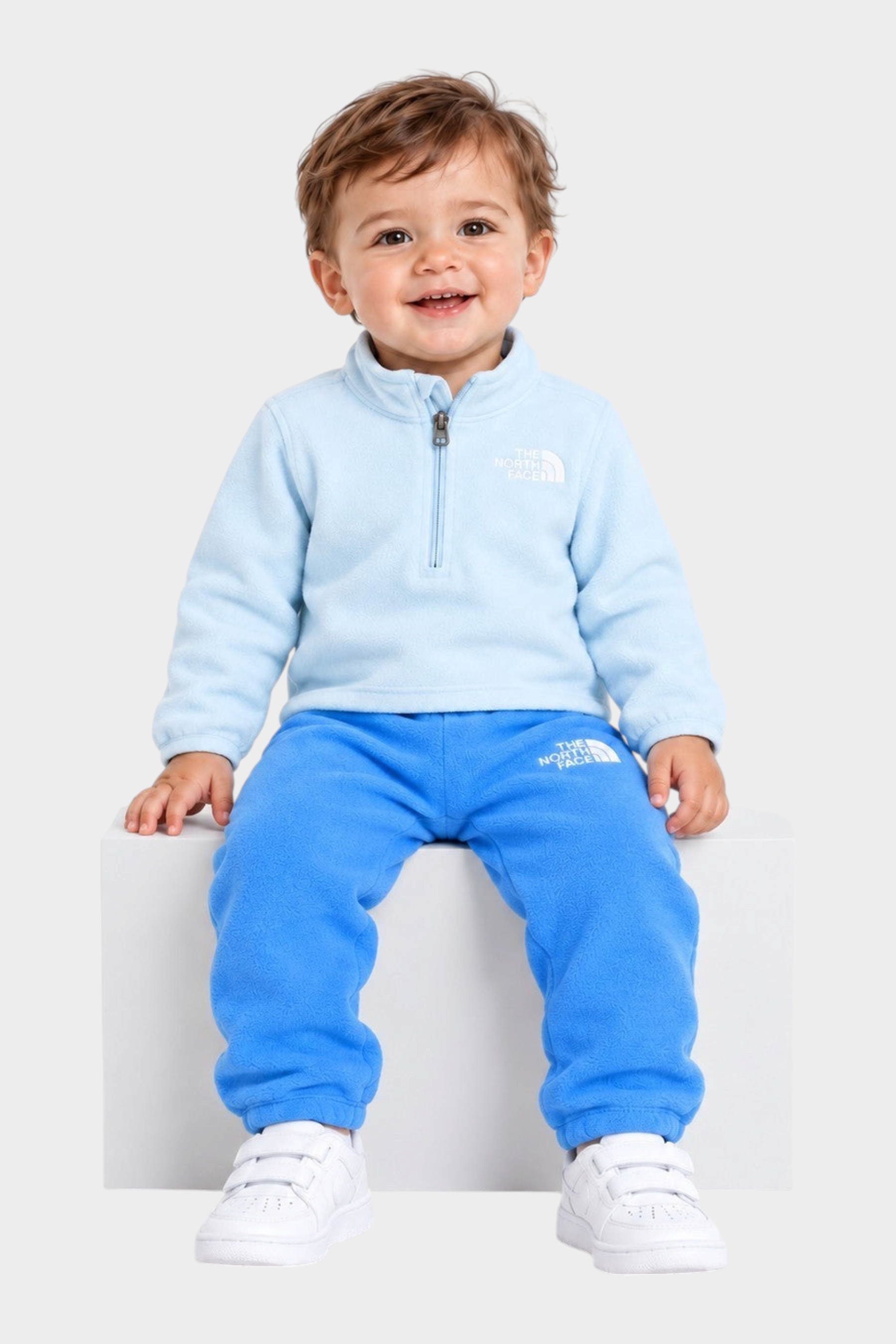 Bambino sorridente indossa completo in pile azzurro Follower SRL composto da felpa con zip e pantaloni coordinati