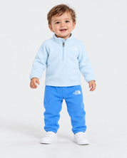 Bambino sorridente indossa completo in pile azzurro Follower SRL THE NORTH FACE con zip e logo ricamato
