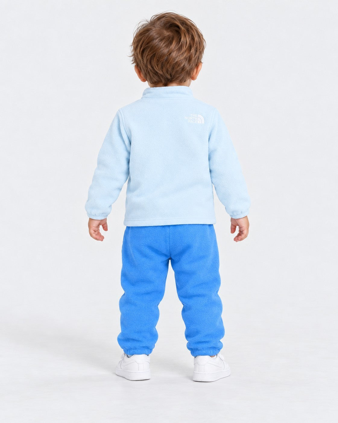Completo due pezzi in pile Follower SRL per bambino, giacca azzurro chiaro e pantaloni blu con logo The North Face
