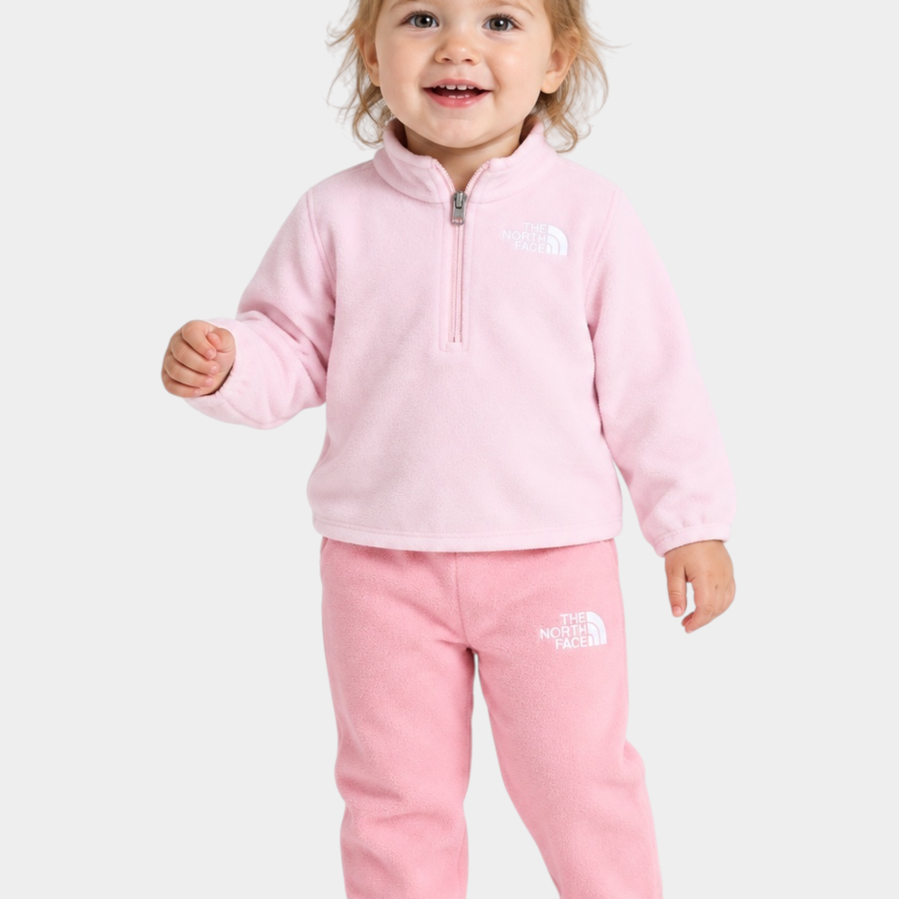 Bambina che indossa il completo due pezzi in pile rosa Follower SRL The North Face con zip corta e logo ricamato