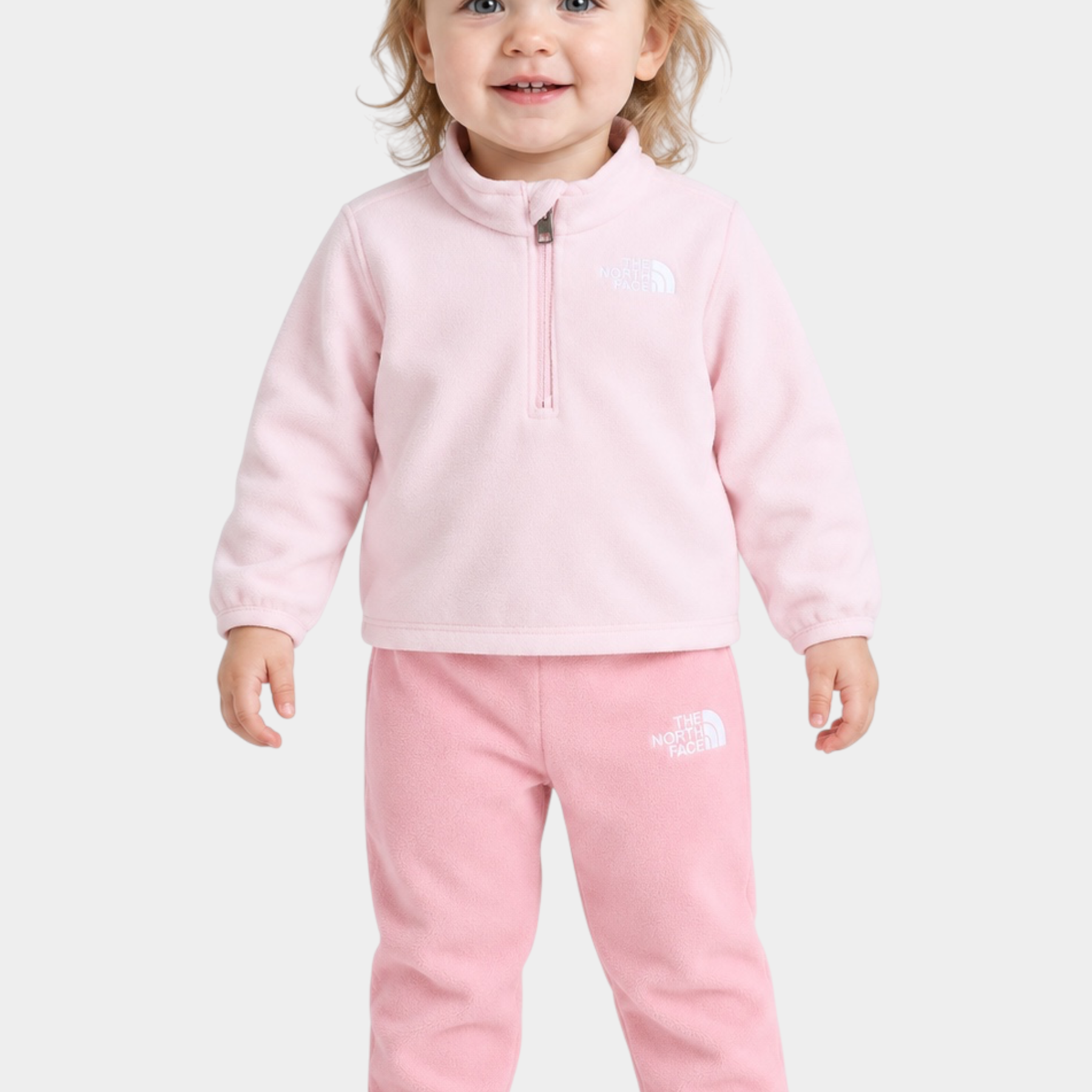 Bambina che indossa un completo due pezzi in pile rosa Follower SRL The North Face con zip corta e logo ricamato
