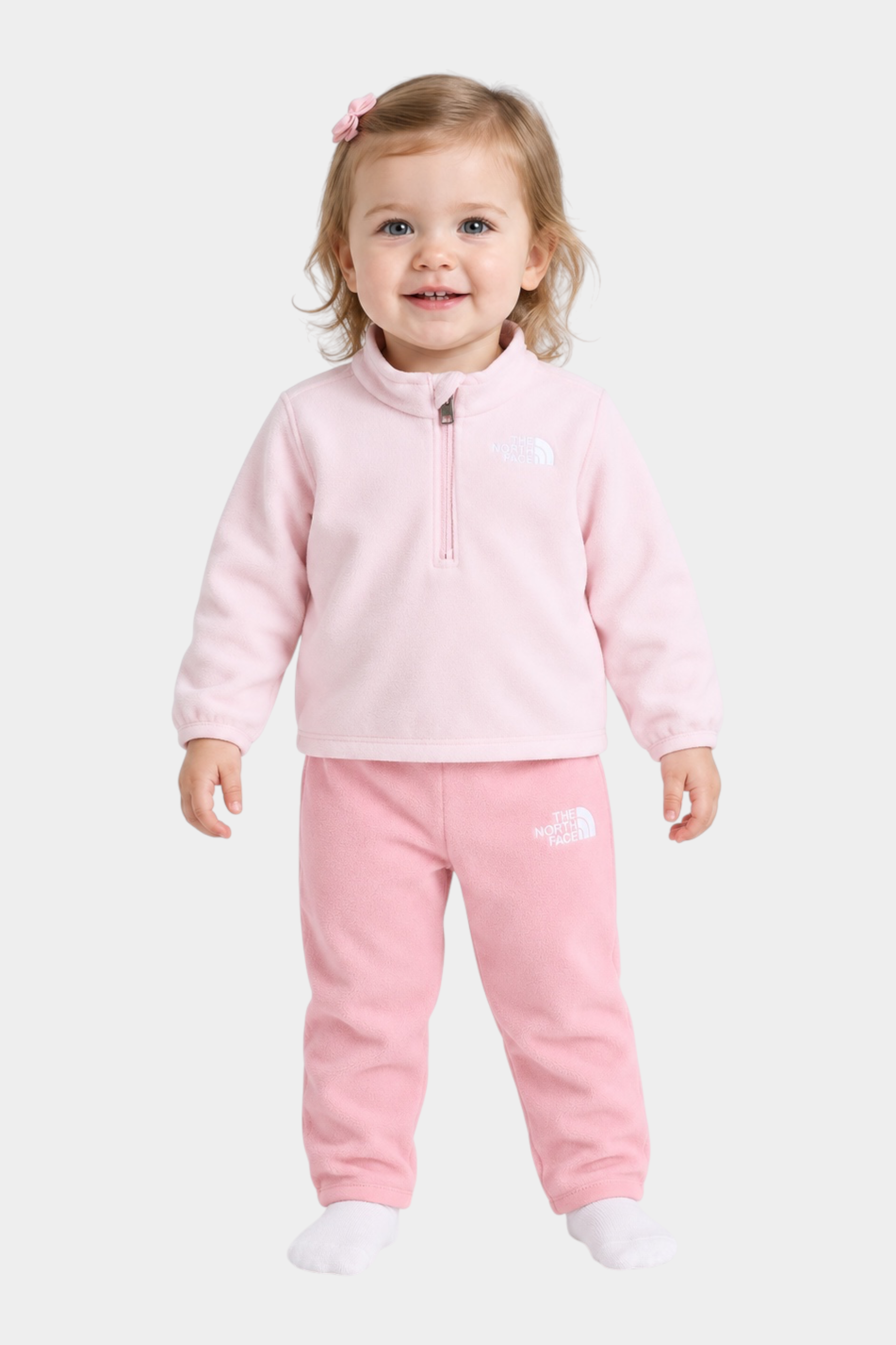 Bambina che indossa un completo due pezzi in pile rosa Follower SRL The North Face con zip corta e logo ricamato