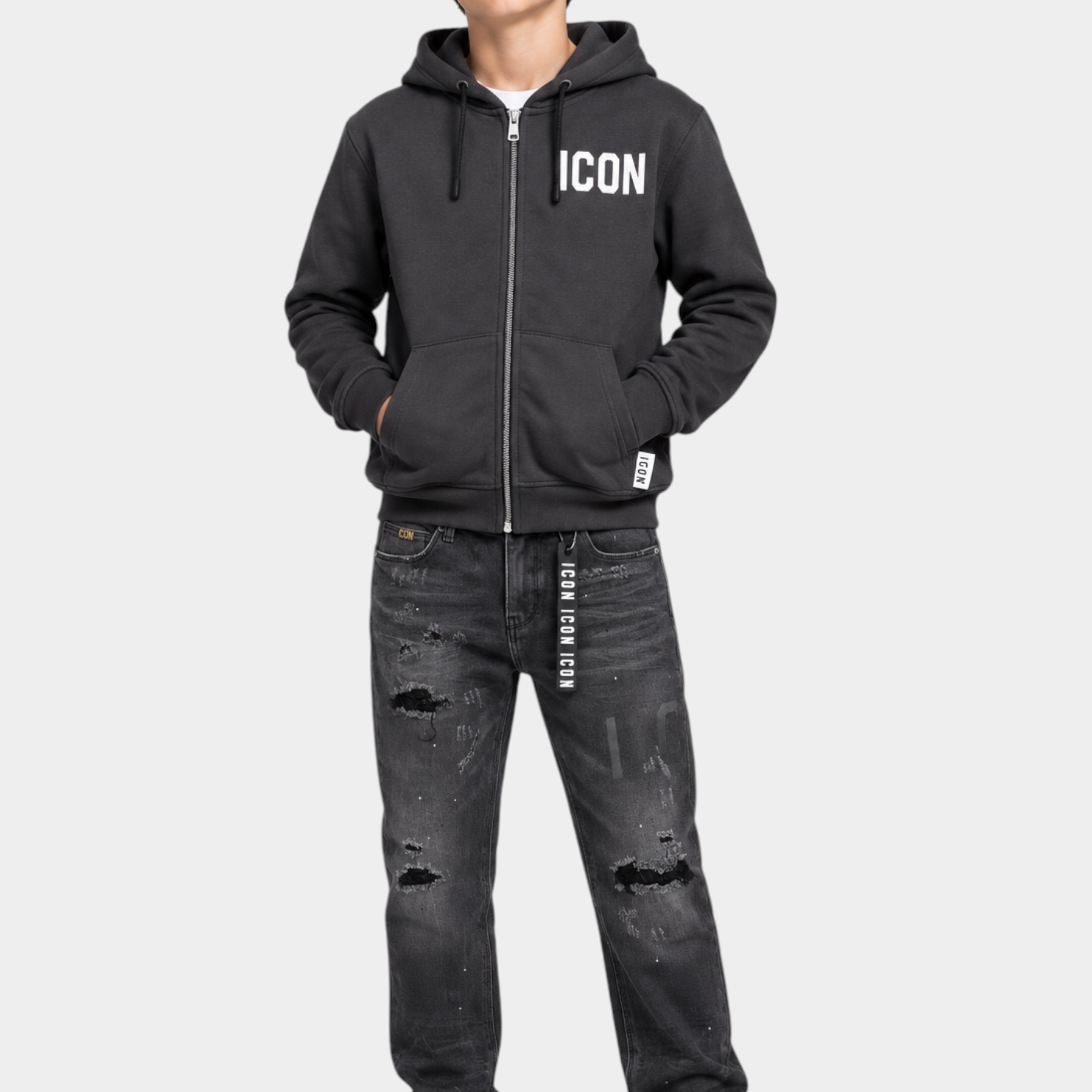 Ragazzo indossa felpa full zip grigia Follower SRL con logo ICON bianco, jeans strappati e scarpe da ginnastica