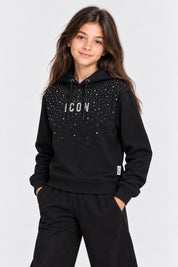 Bambina indossa felpa nera Follower SRL con cappuccio, decorata da strass scintillanti e scritta ICON sul petto