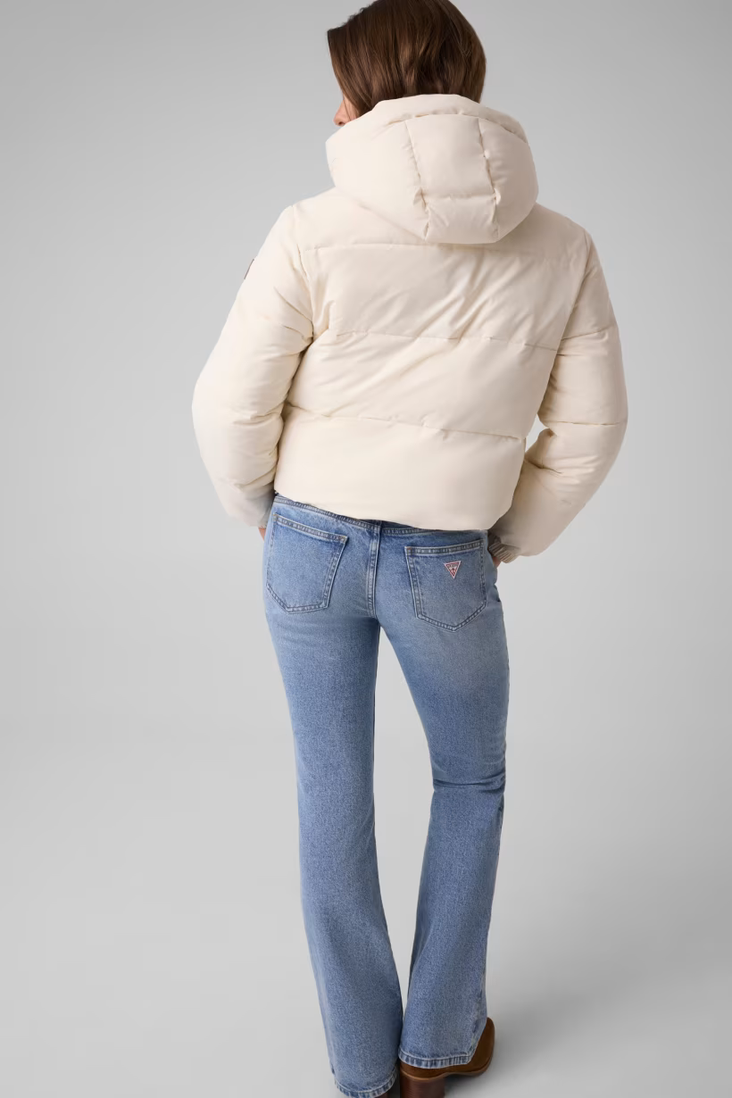Modella indossa giacca imbottita corta avorio con cappuccio di Follower SRL abbinata a jeans azzurri