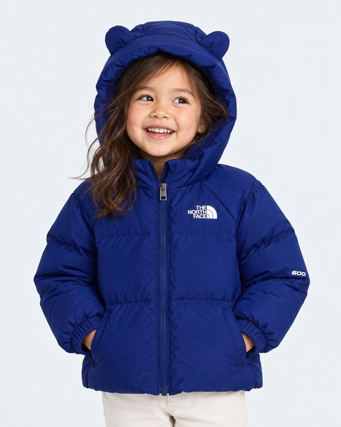 Bambina che indossa una giacca in piumino blu Follower SRL con cappuccio e orecchie decorative