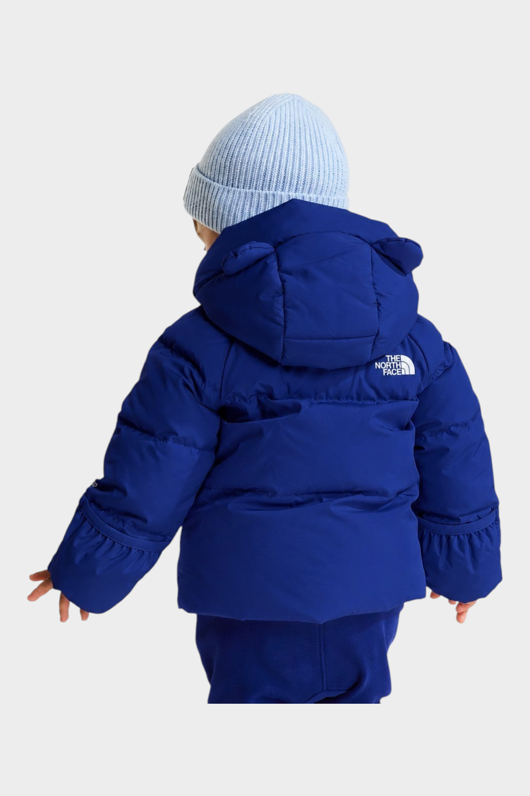 Giacca in piumino blu Follower SRL con cappuccio e logo The North Face vista posteriore su bambino con berretto