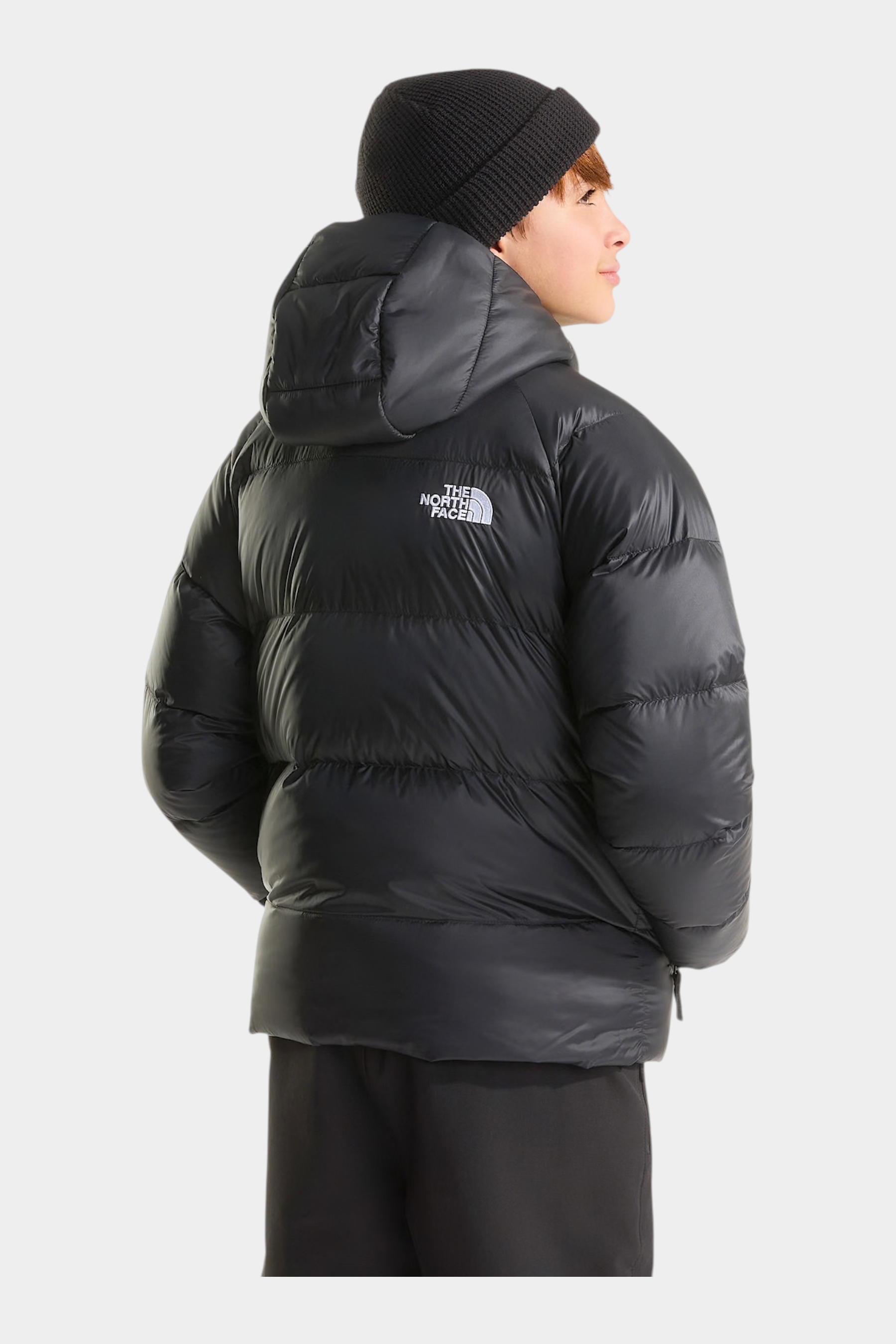 Ragazzo indossa giacca in piumino nera con cappuccio Follower SRL THE NORTH FACE, vista posteriore