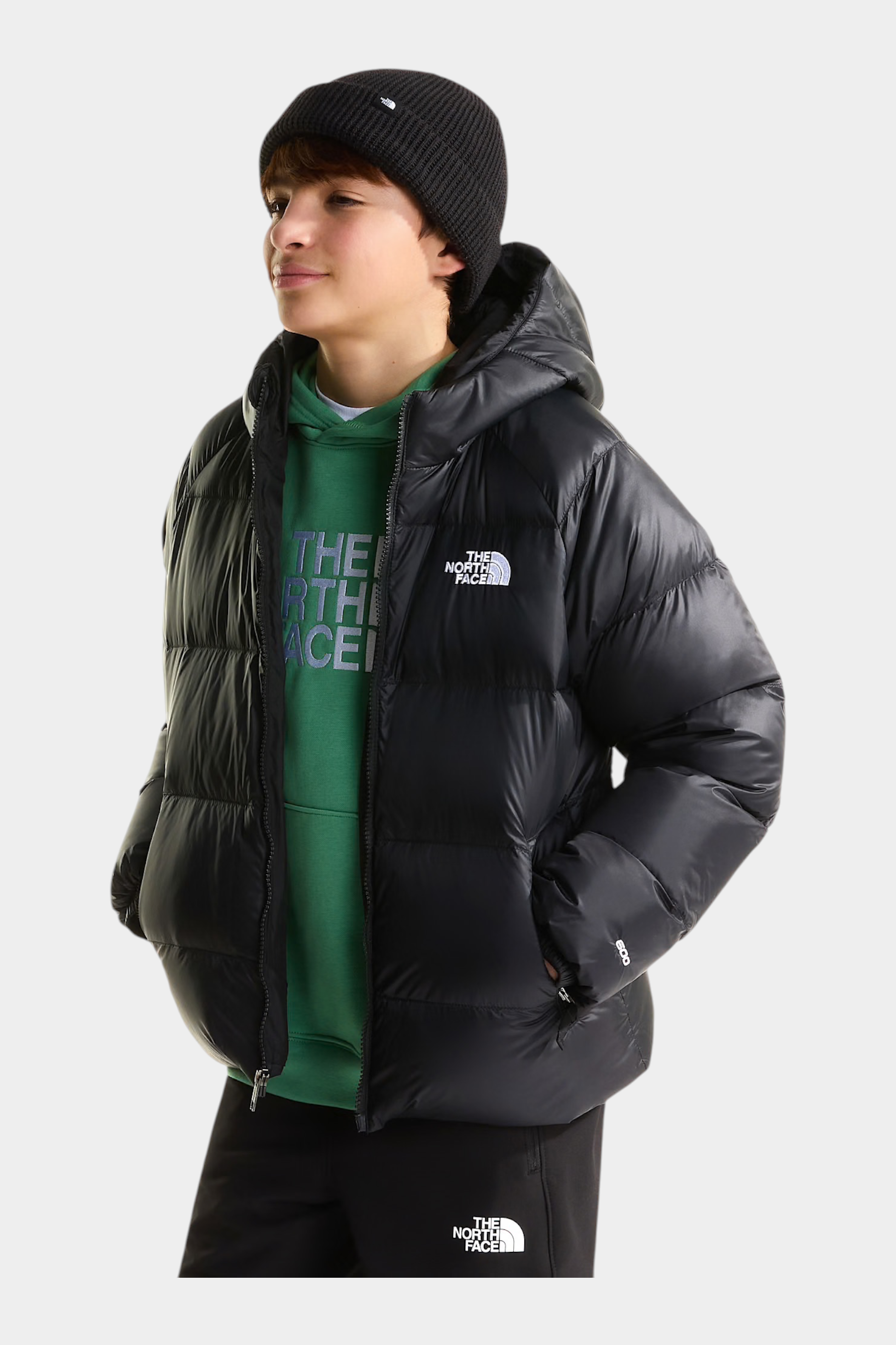 Ragazzo indossa giacca in piumino nera con cappuccio Follower SRL THE NORTH FACE, vista di profilo