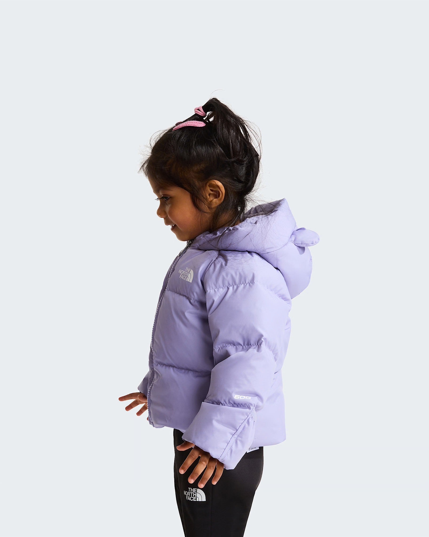 Bambina indossa giacca in piumino viola The North Face con fodera in pile, vista laterale, Follower SRL