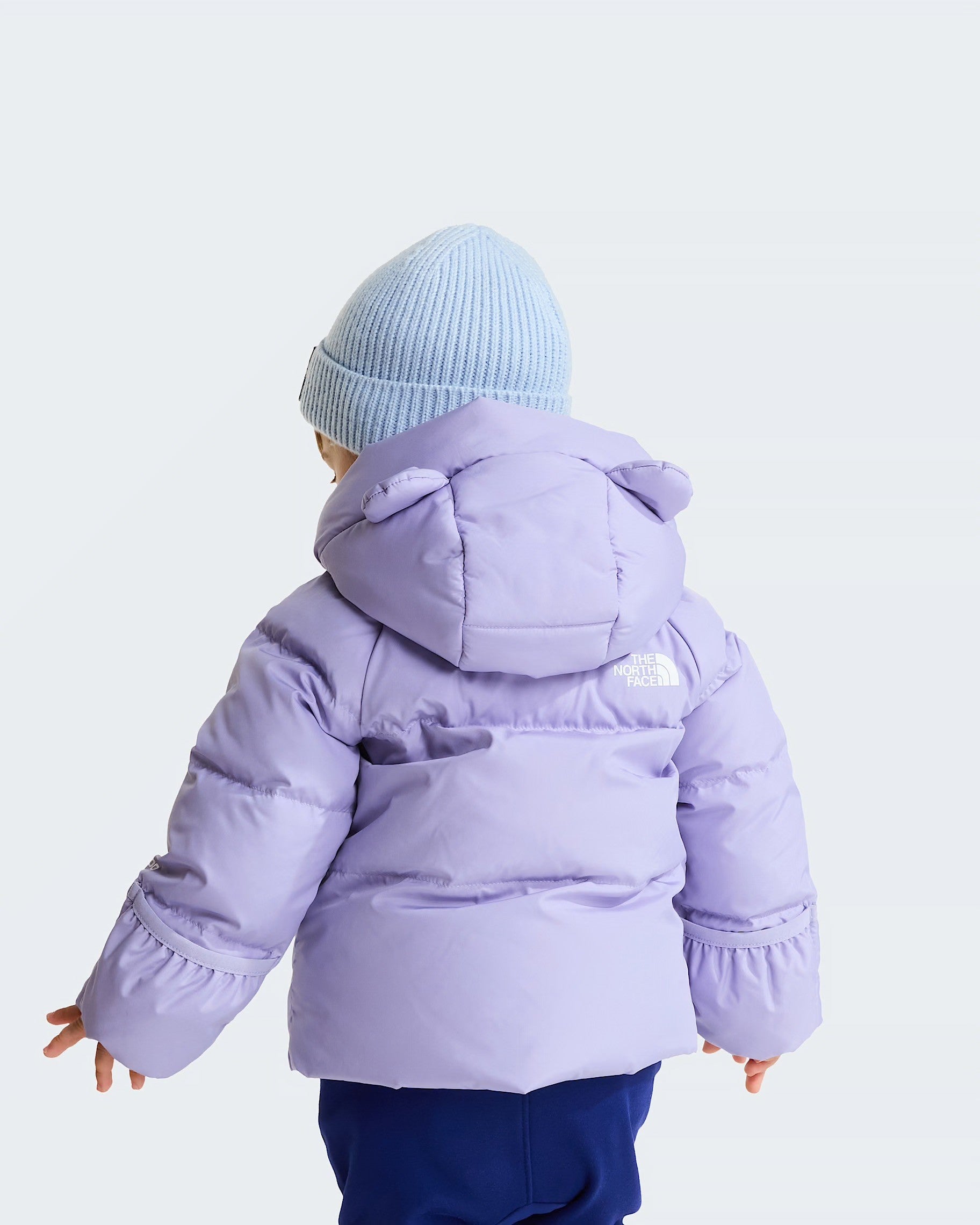 Bambino con giacca in piumino viola Follower SRL con cappuccio e logo The North Face, vista posteriore