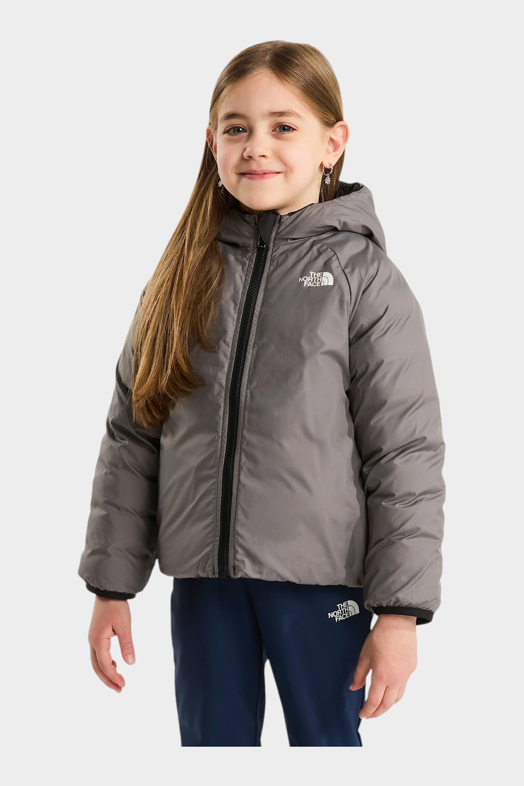 Bambina che indossa una giacca reversibile imbottita con cappuccio grigia Follower SRL The North Face