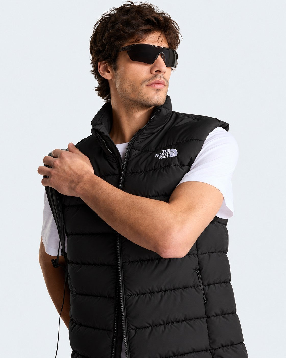 Modello indossa gilet imbottito nero Follower SRL The North Face con tecnologia WindWall e chiusura a zip