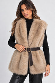 Gilet in pelliccia sintetica beige Follower SRL con cintura marrone in vita indossato su maglione nero