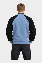 Vista posteriore del giubbino bomber Follower SRL azzurro con maniche in tessuto teddy nero e colletto a righe