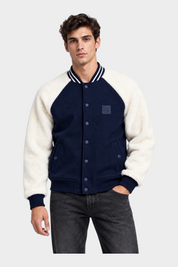 Modello indossa giubbino bomber Follower SRL blu con maniche in pile bianco e chiusura a bottoni