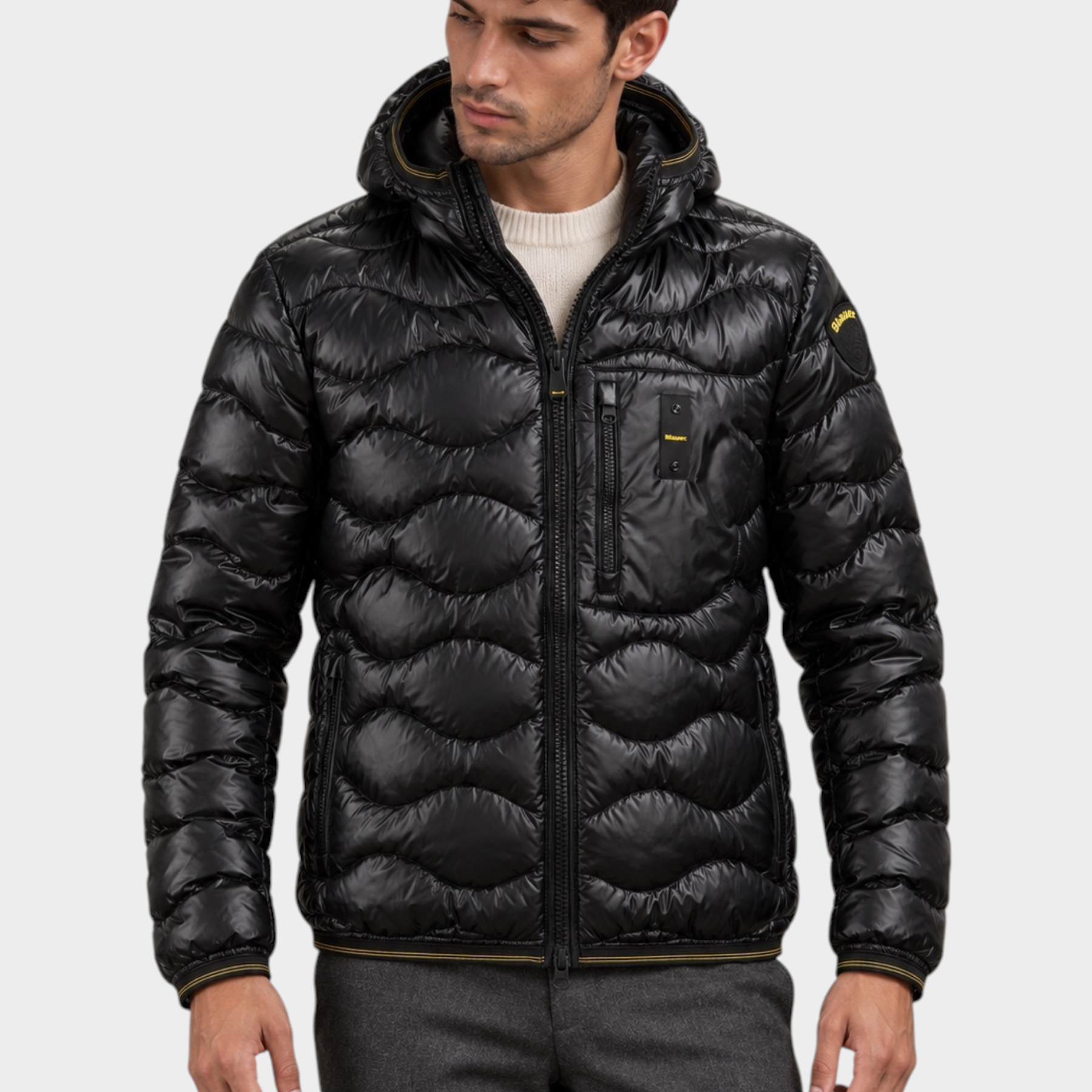 Modello indossa giubbino Follower SRL nero trapuntato a onde con cappuccio e chiusura zip frontale