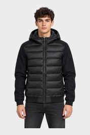 Modello indossa giubbino Follower SRL nero in piumino e nylon con cappuccio e chiusura a zip frontale