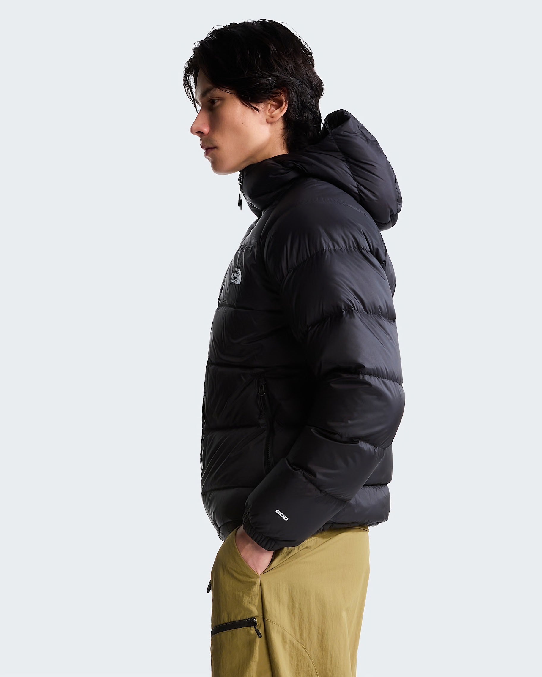 Modello indossa giubbino con cappuccio in piumino nero Follower SRL Hydrenalite con logo The North Face