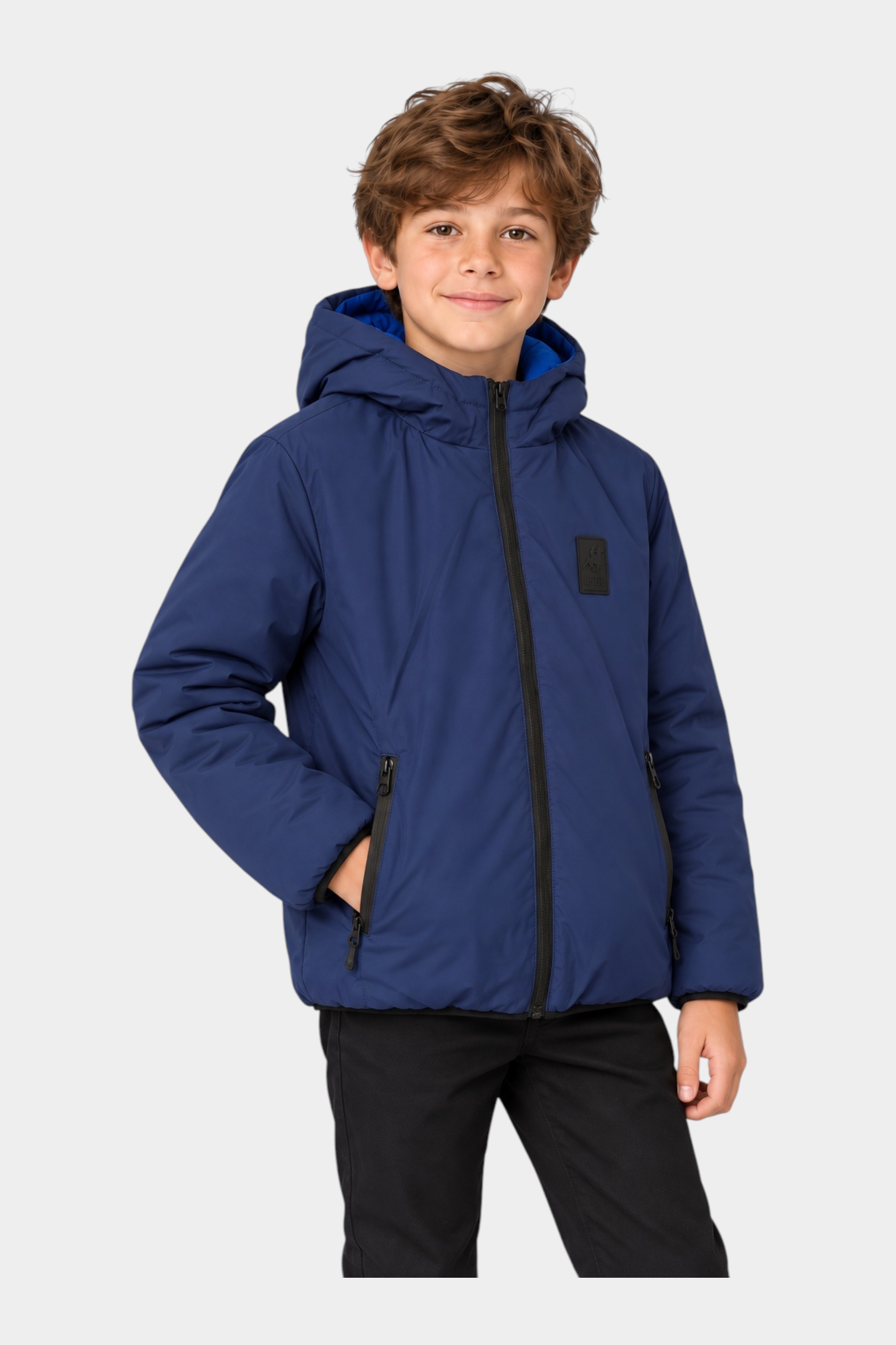 Ragazzo indossa un giubbino reversibile blu con cappuccio di Follower SRL, design imbottito con zip nera