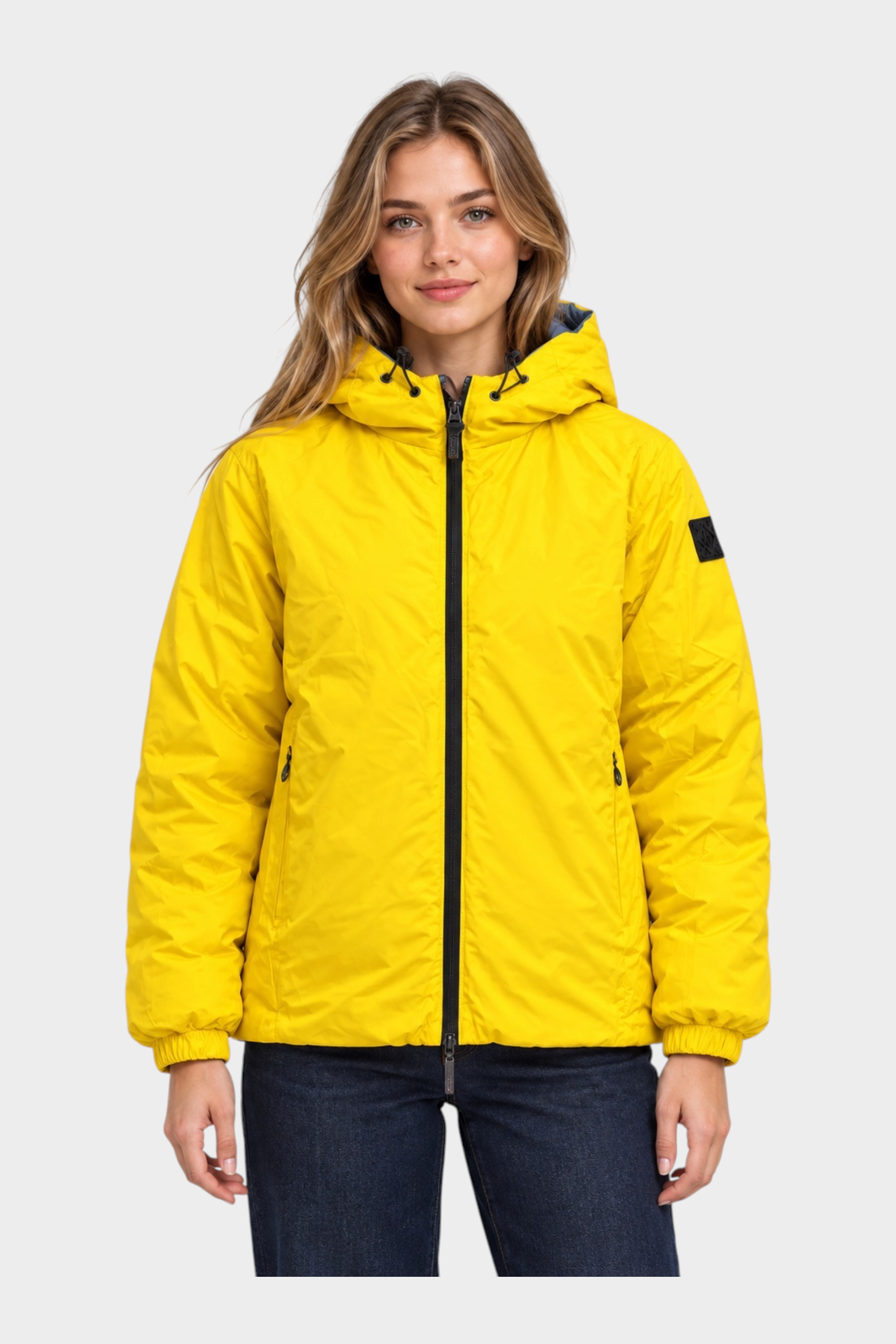Modella indossa giubbino reversibile Follower SRL giallo con cappuccio, zip nera e polsini elasticizzati