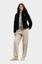 Modella indossa giubbino in velluto nero lucido Blauer con cappuccio, abbinato a pantaloni beige, Follower SRL