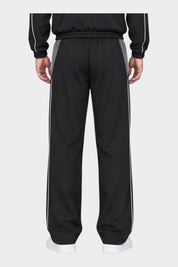 Vista posteriore dei pantaloni jogger Follower SRL GUESS in nylon nero con profili bianchi e inserti grigi