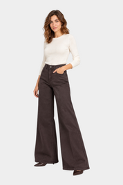 Modella indossa jeans a gamba larga marroni Follower SRL abbinati a un maglione bianco a maniche lunghe