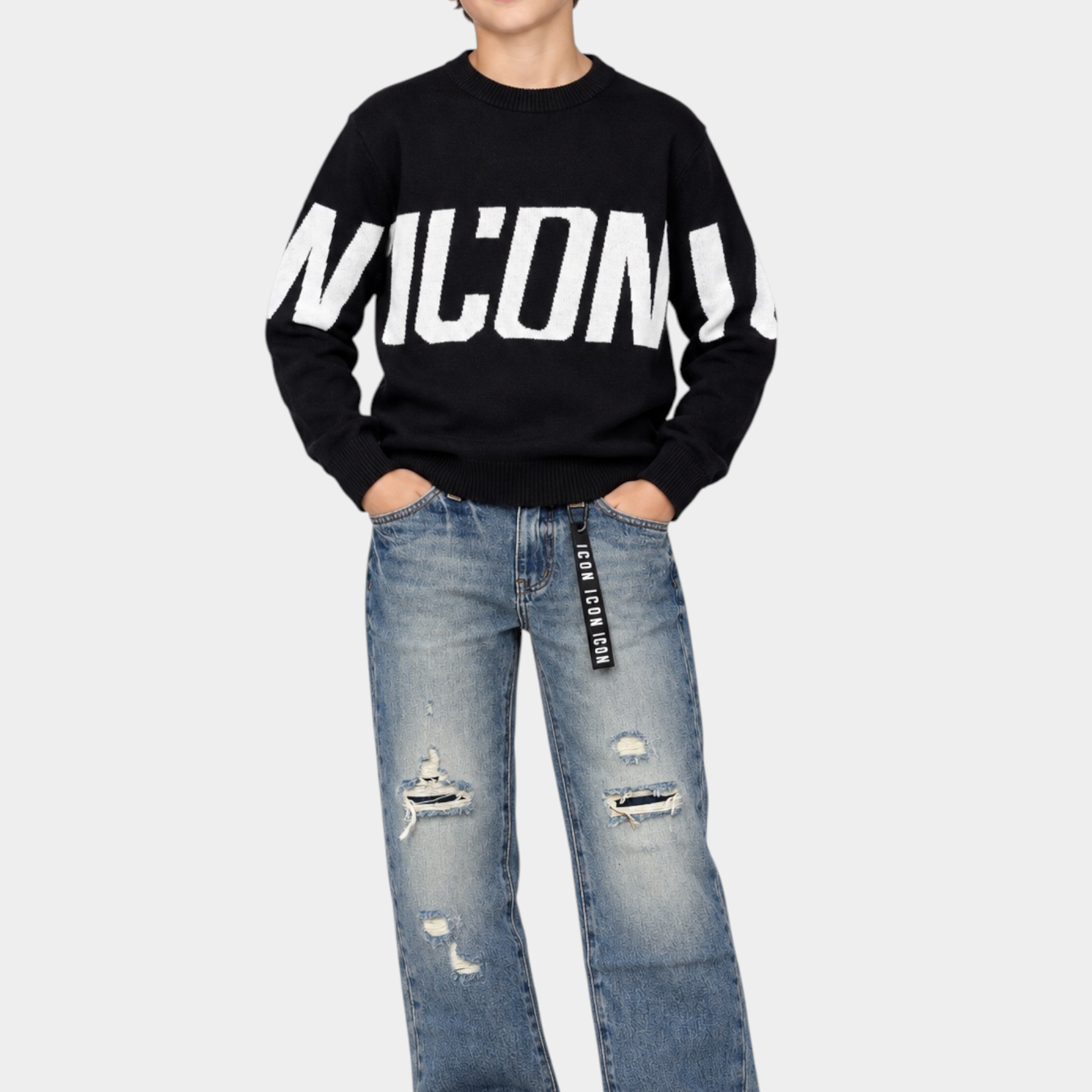 Ragazzo indossa jeans larghi Follower SRL grigi con strappi e maglione nero con logo ICON bianco