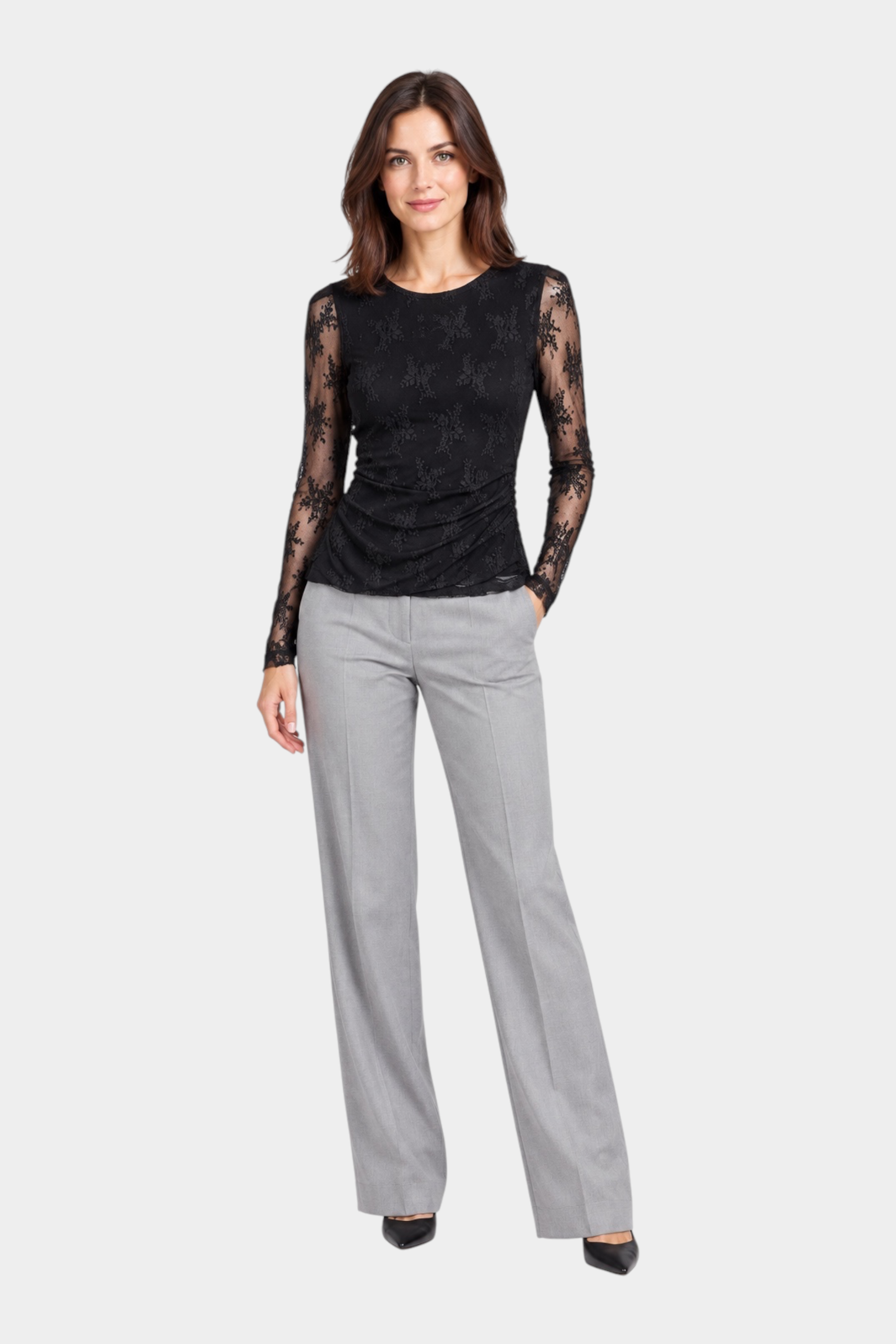 Modella indossa maglia Follower SRL nera in pizzo ricamato a maniche lunghe con pantaloni grigi eleganti