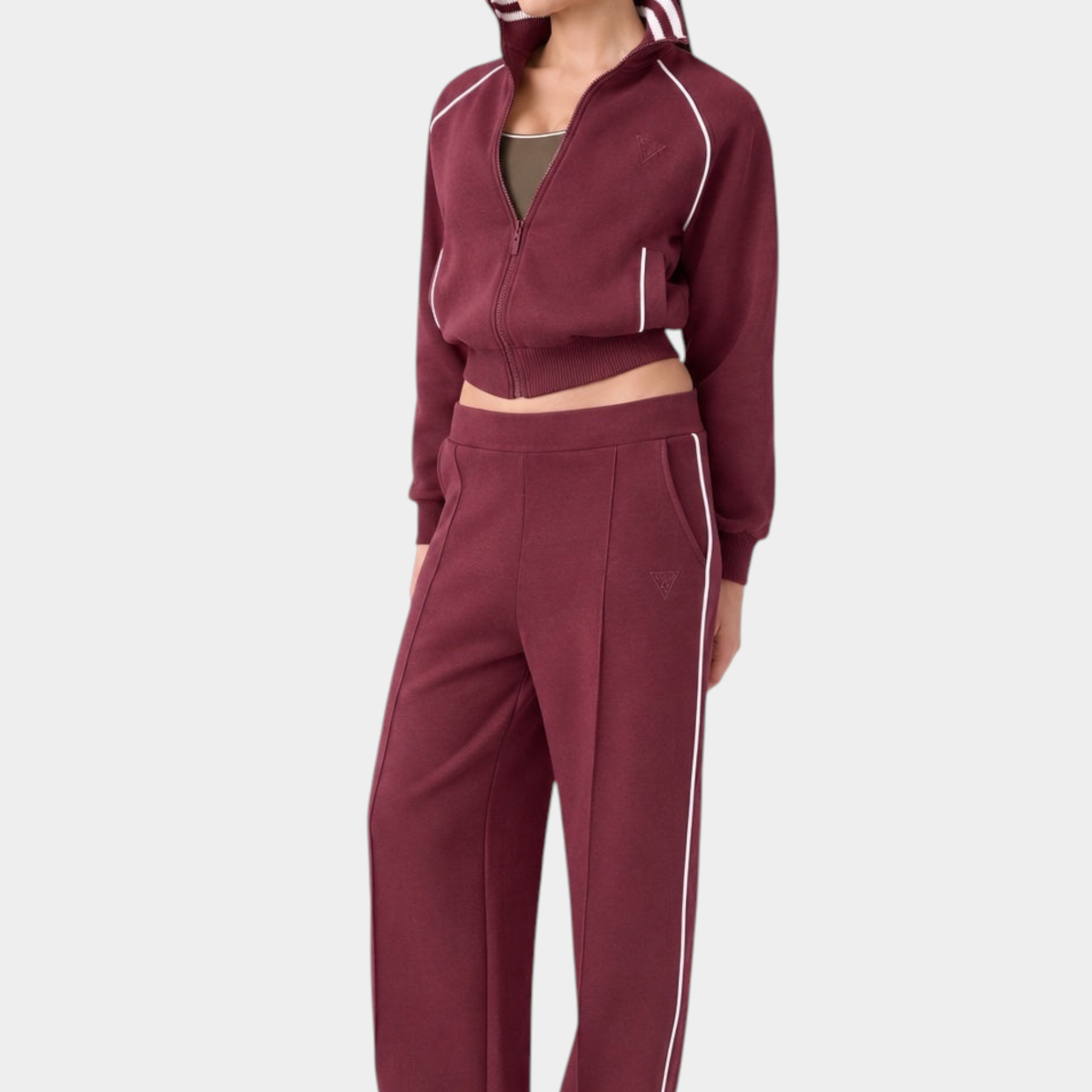 Modella indossa pantalone jogger bordeaux GUESS con banda laterale bianca, parte di una tuta Follower SRL