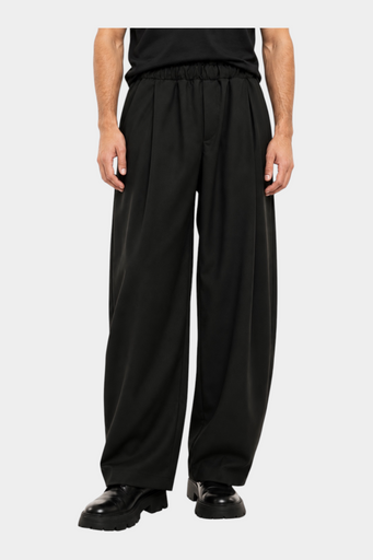 Pantaloni Follower SRL baggy-fit neri da uomo con pinces e vita elastica indossati con scarpe nere