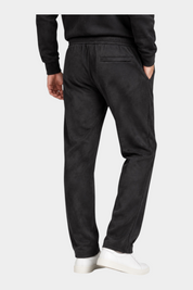 Pantaloni jogger da uomo Follower SRL in ciniglia nera, vista posteriore con tasca a filetto e sneakers bianche
