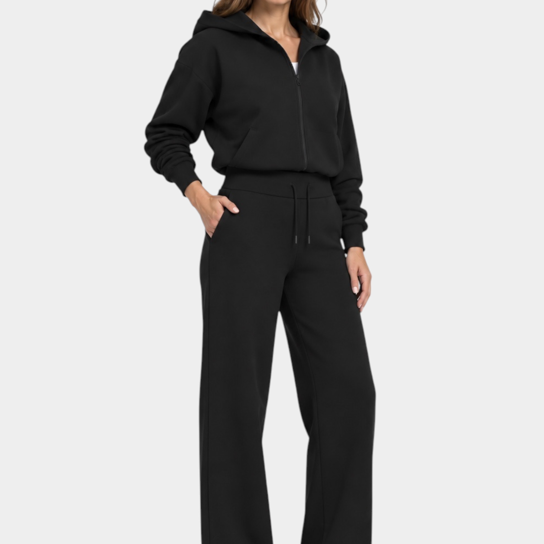 Modella indossa pantaloni jogger neri GUESS con logo 4G e felpa con zip abbinata, stile casual Follower SRL