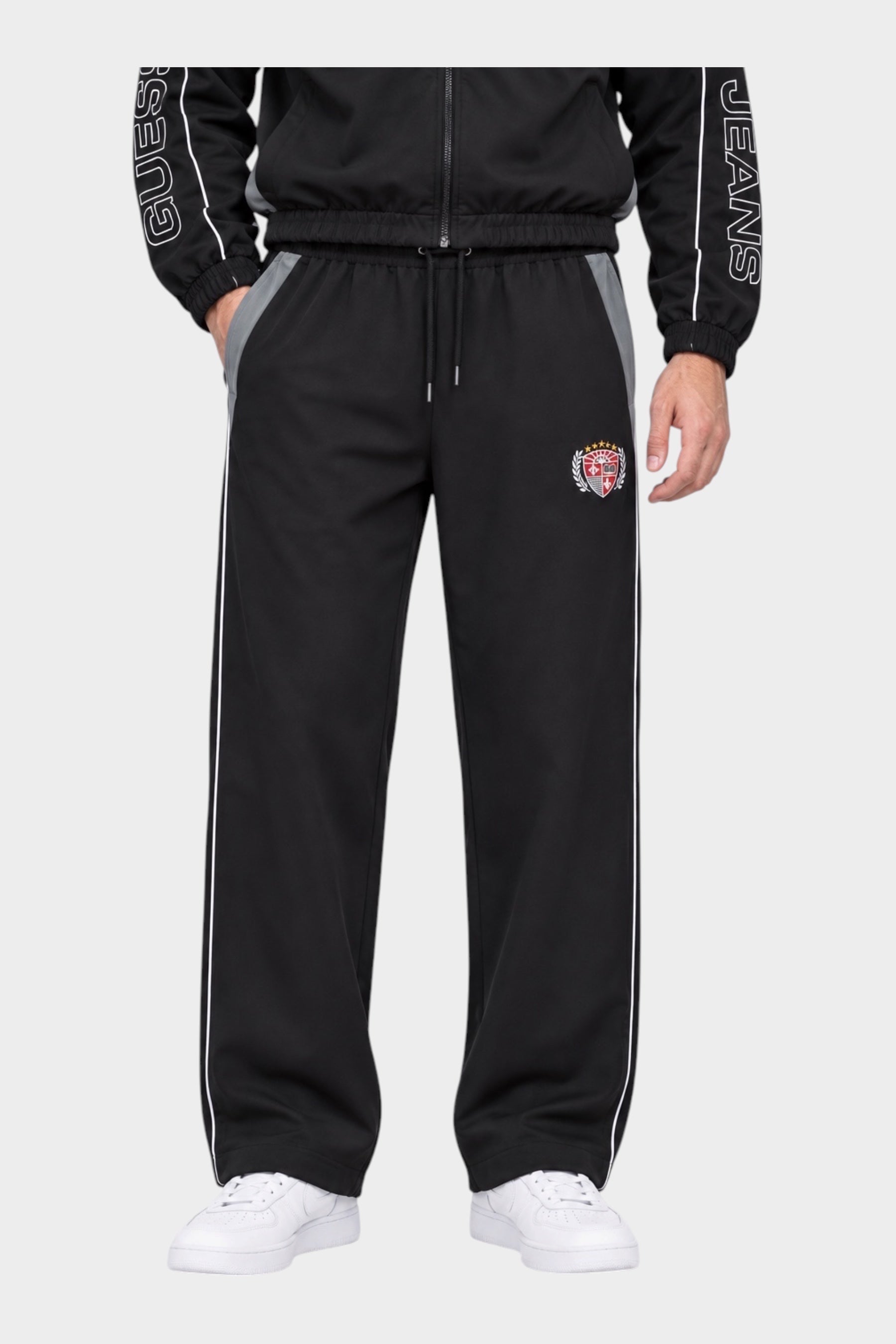 Pantaloni jogger Follower SRL GUESS neri in nylon con profili bianchi, inserti grigi e stemma applicato