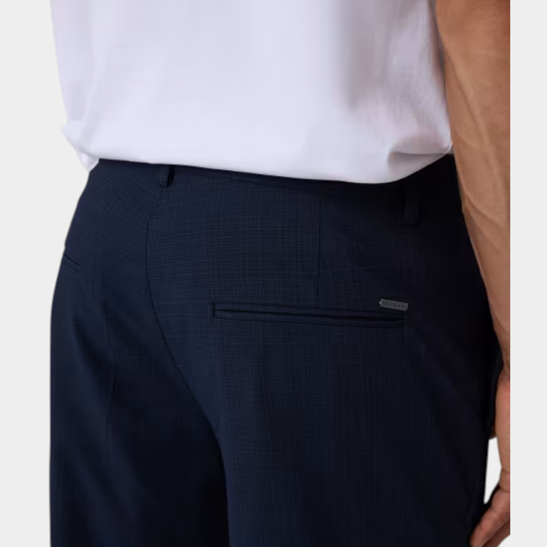 Pantaloni classici da uomo blu scuro GUESS con texture micro-fantasia, indossati con t-shirt bianca Follower SRL