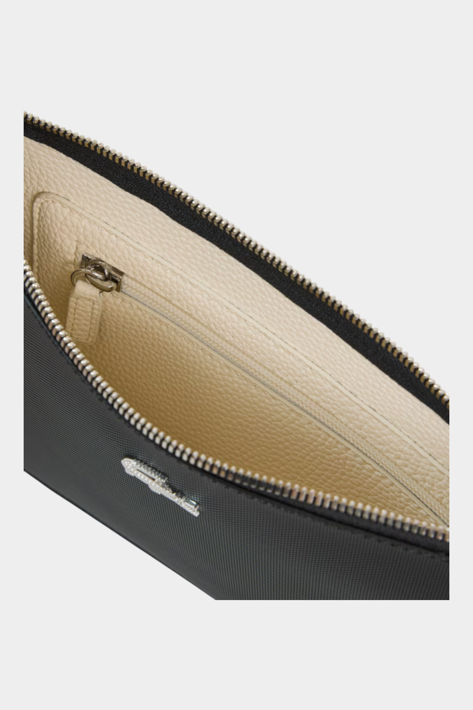 Interno della pochette Follower SRL LACOSTE in canvas piqué nero con fodera color crema e chiusura a zip