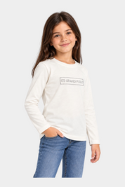 Bambina indossa una t-shirt bianca a maniche lunghe Follower SRL con logo US GRAND POLO decorato con strass