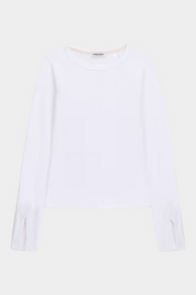 Top bianco a maniche lunghe GUESS con dettagli in pizzo sui polsini, proposto da Follower SRL