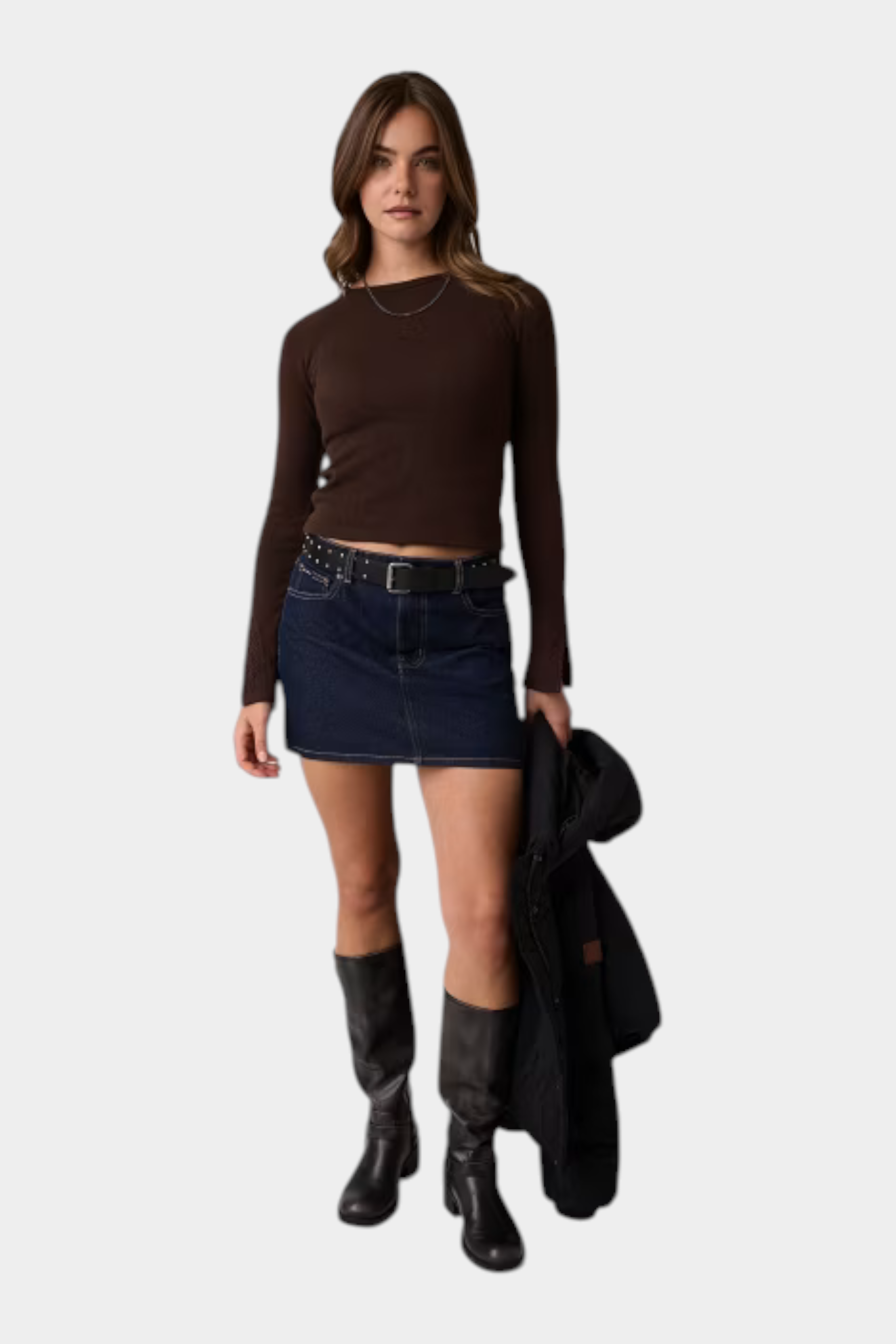 Modella indossa top a maniche lunghe marrone Follower SRL con gonna di jeans scura e stivali alti neri