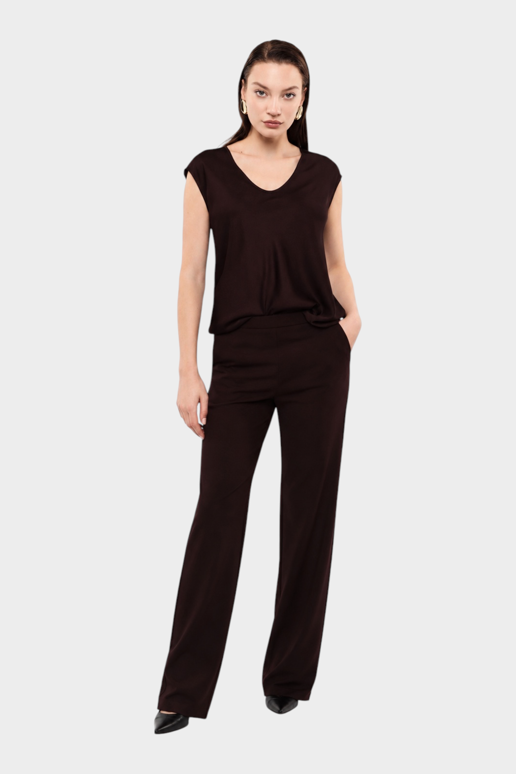 Modella indossa un top IMPERIAL viola con ampio scollo a V e pantaloni coordinati a gamba dritta Follower SRL